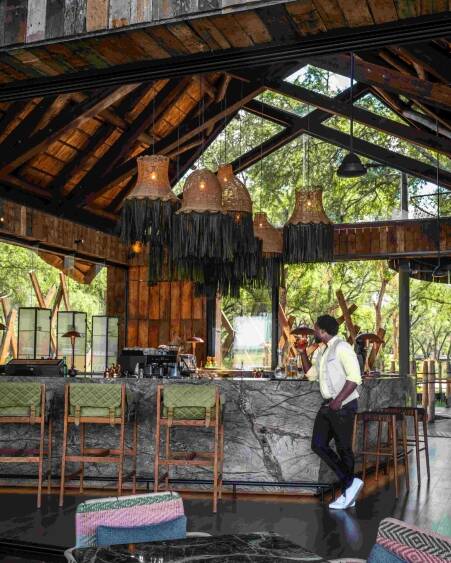 Man standing next to lodge bar