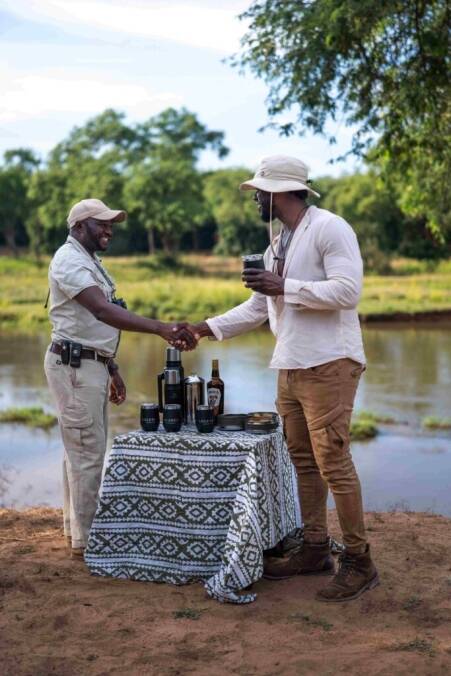 Man shaking hand with safari guide during sundowners